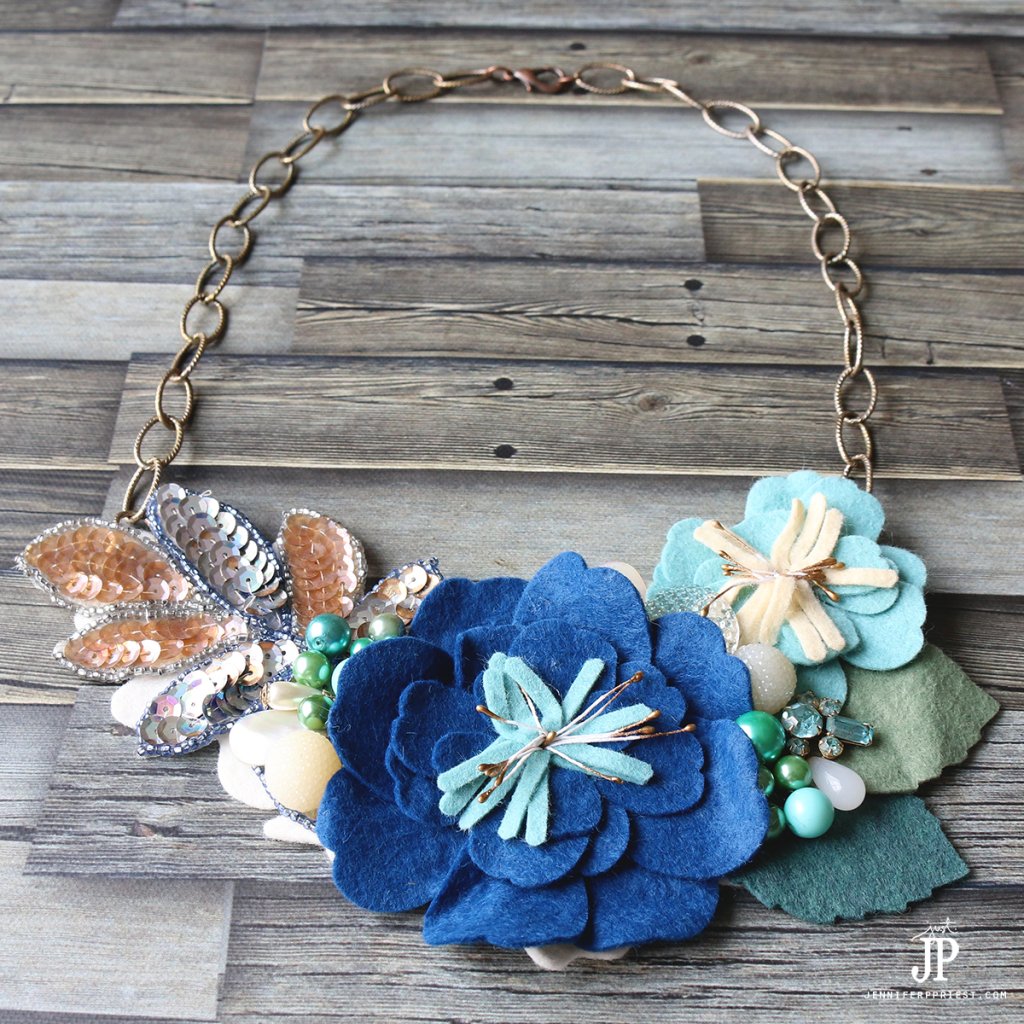 Turn die cut flowers and broken vintage jewelry into a gorgeous bib style necklace. NO jewelry skills needed - watch the video tutorial to see how!