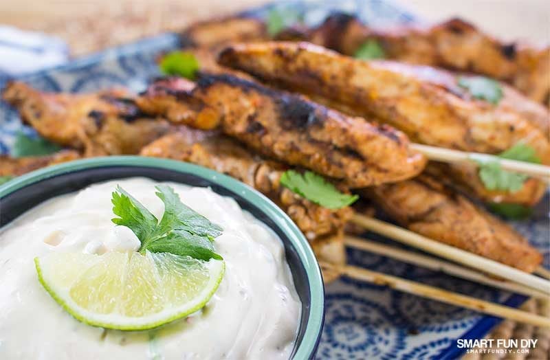 creamy chipotle dip in bowl with platter chicken skewers