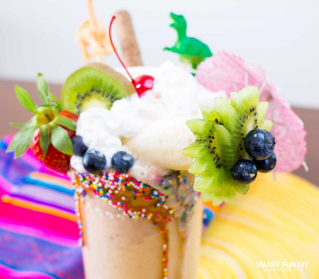 vegan banana date milkshake with fruit and toy toppers