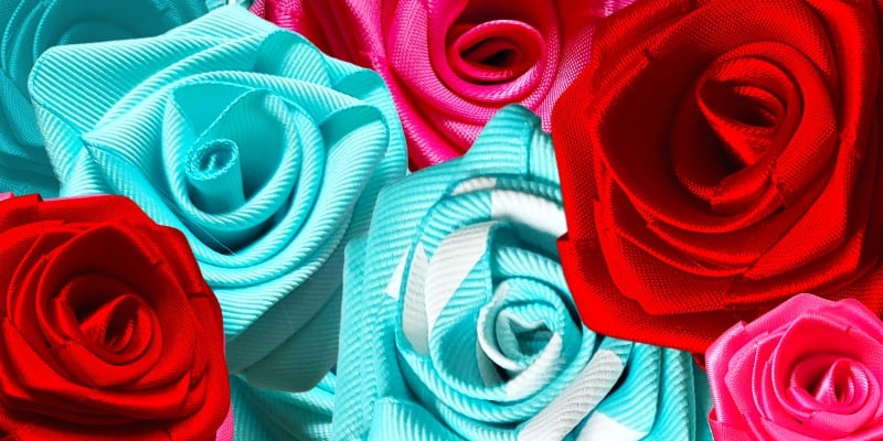 Layers of blue pink and red ribbon roses
