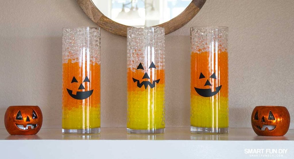 Candy Corn Vases with Jack-O-Lantern Faces! Halloween Decor is easy with GEMNIQUE Water Beads. See how to make this display for under $15!