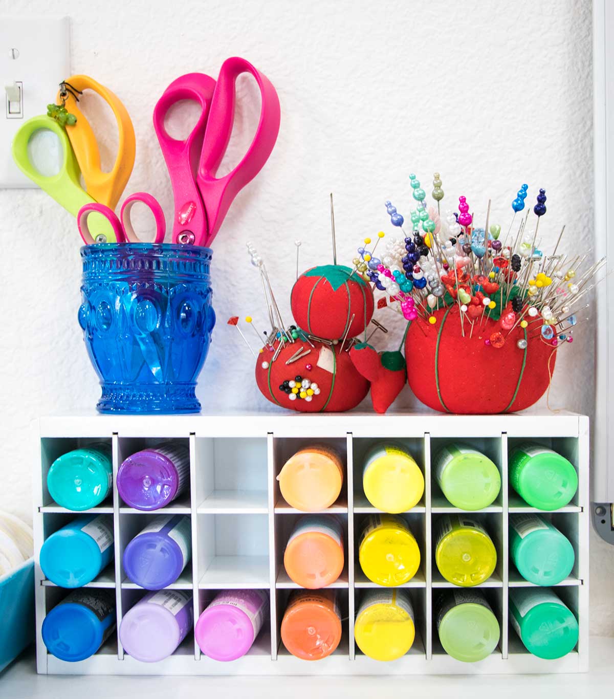 Paint storage box from artbin with cup of scissors and pin cushions on top