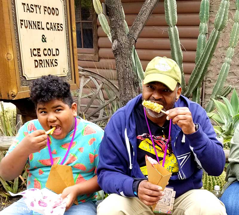 Family eating fries and elote from Knott's Berry Farm Boysenberry Festival