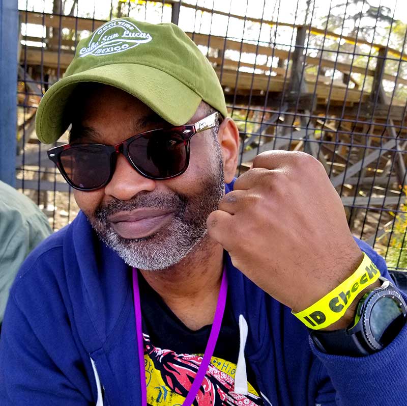 Man wearing yellow paper wristband for Knott's Berry Farm Wine Tasting Card ID Check