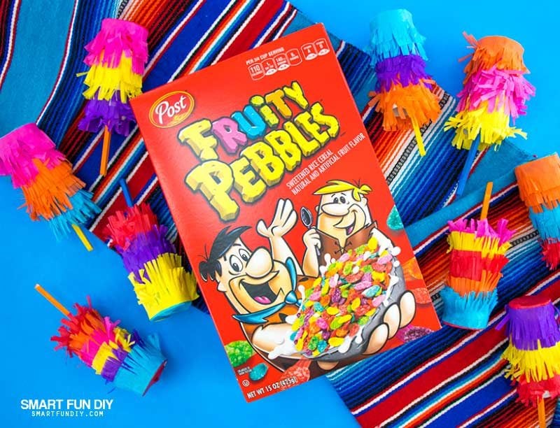 Box of Fruity Pebbles cereal with DIY confetti poppers covered with tissue paper