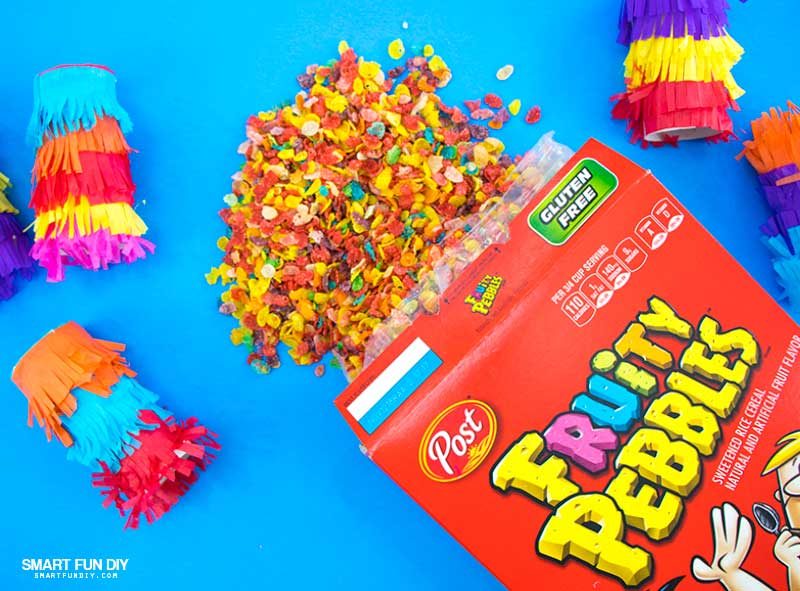 DIY confetti poppers covered with tissue paper and filled with Fruity Pebbles Cereal