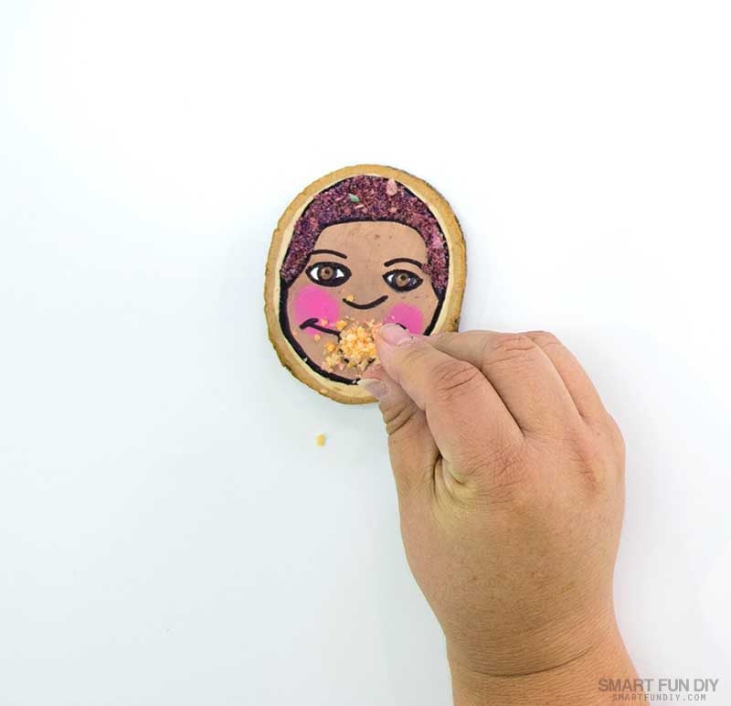 sprinkle crushed cereal onto glue on self portrait