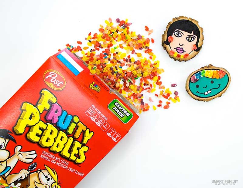 place whole piees of fruity pebbles cereal onto glue on wood slice