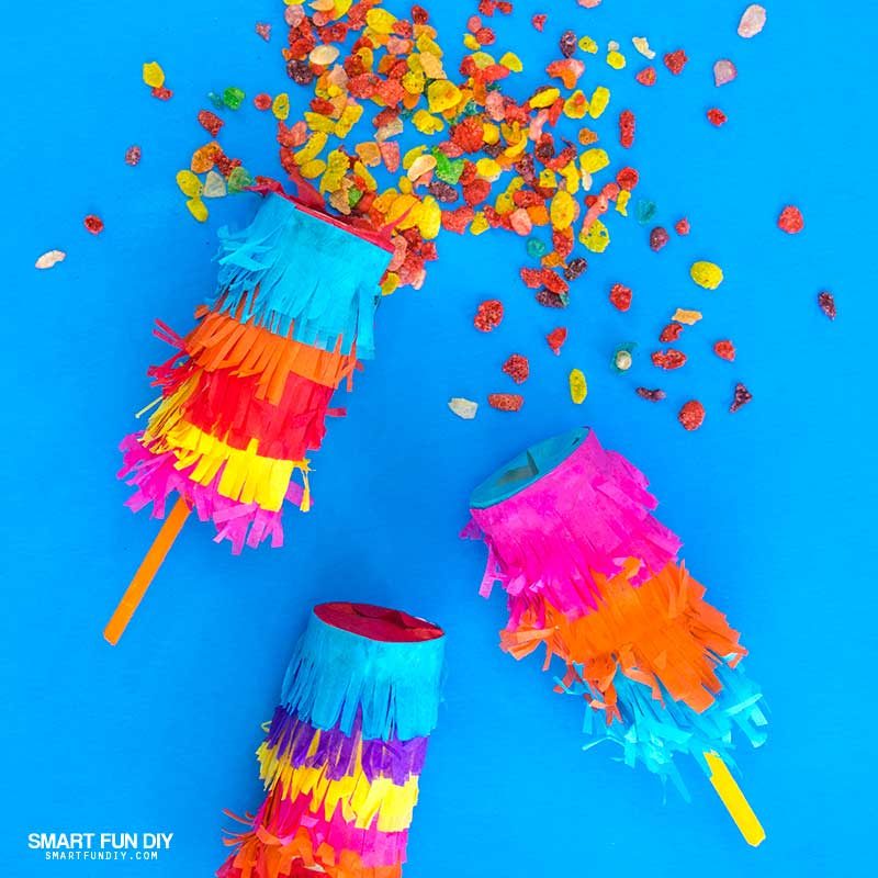 DIY confetti poppers covered with tissue paper and filled with Fruity Pebbles Cereal