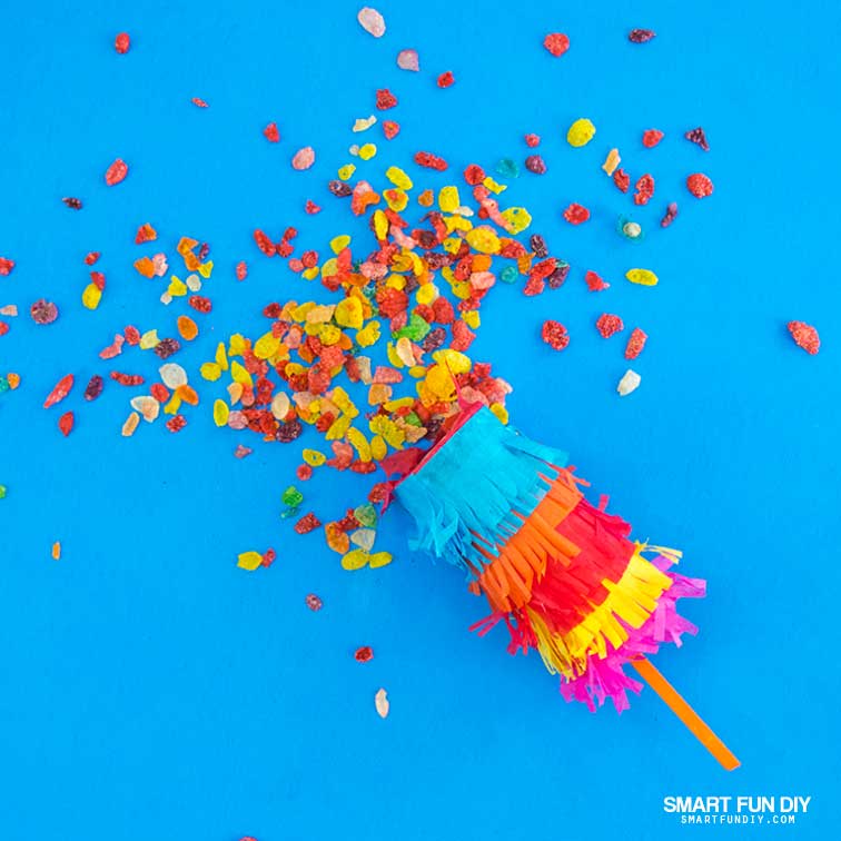 DIY confetti poppers covered with tissue paper and filled with Fruity Pebbles Cereal