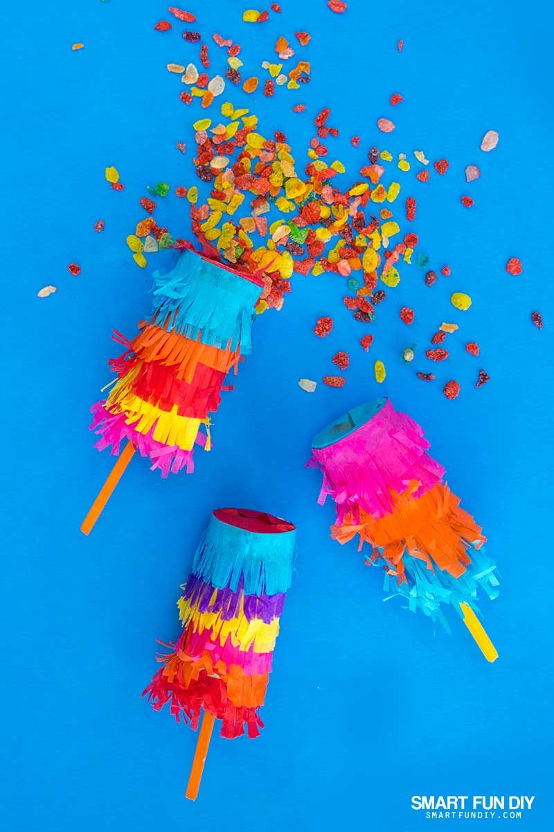 DIY confetti poppers covered with tissue paper and filled with Fruity Pebbles Cereal