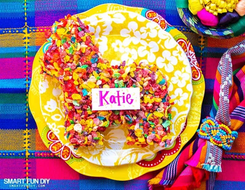DIY pinata from cardboard covered in cereal used as placecard