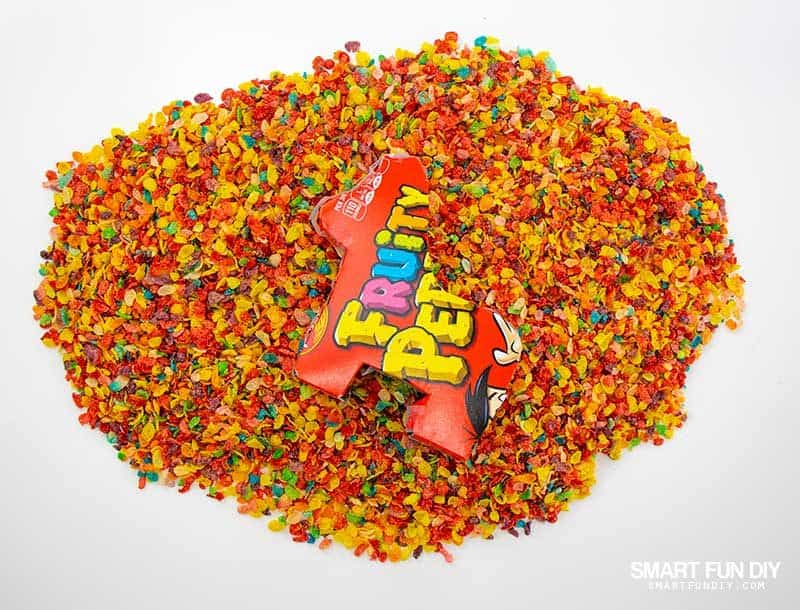 Pile of Fruity Pebbles cereal with DIY Pinata laying on top