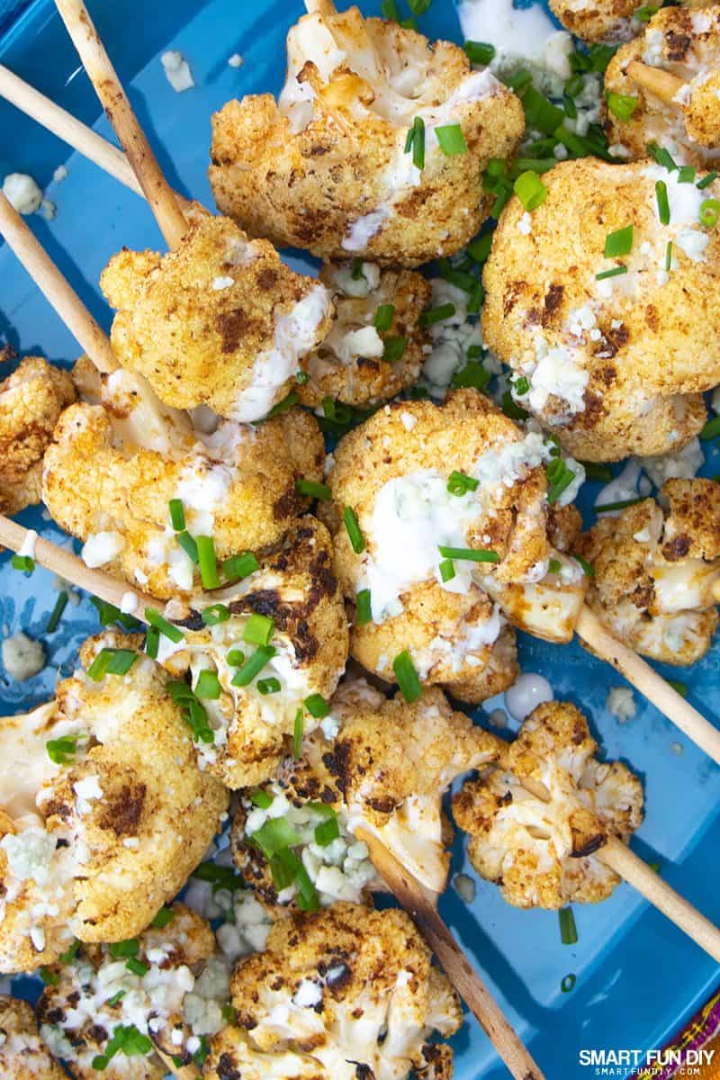 Spicy cauliflower lollipops on a blue platter Spicy cauliflower lollipops on a blue platter