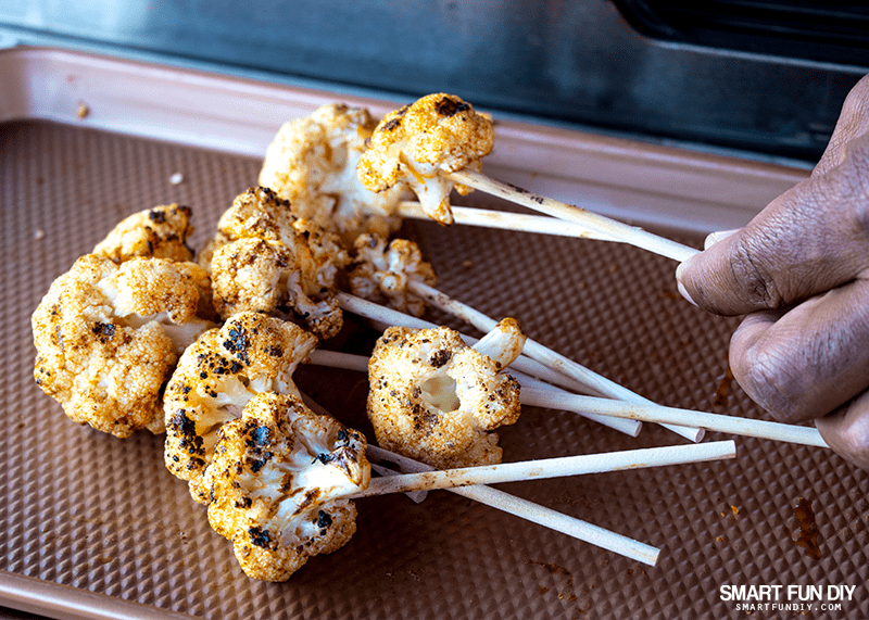 Remove cooked cauliflower from grill Removing cauliflower from grill - another angle