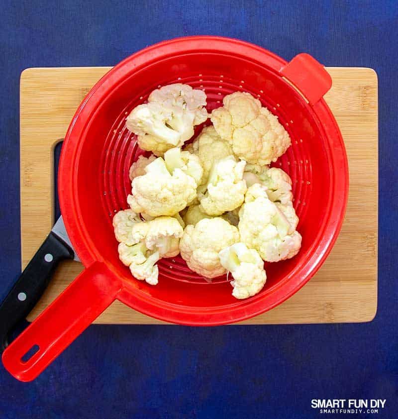 caulfilower florets in red colander