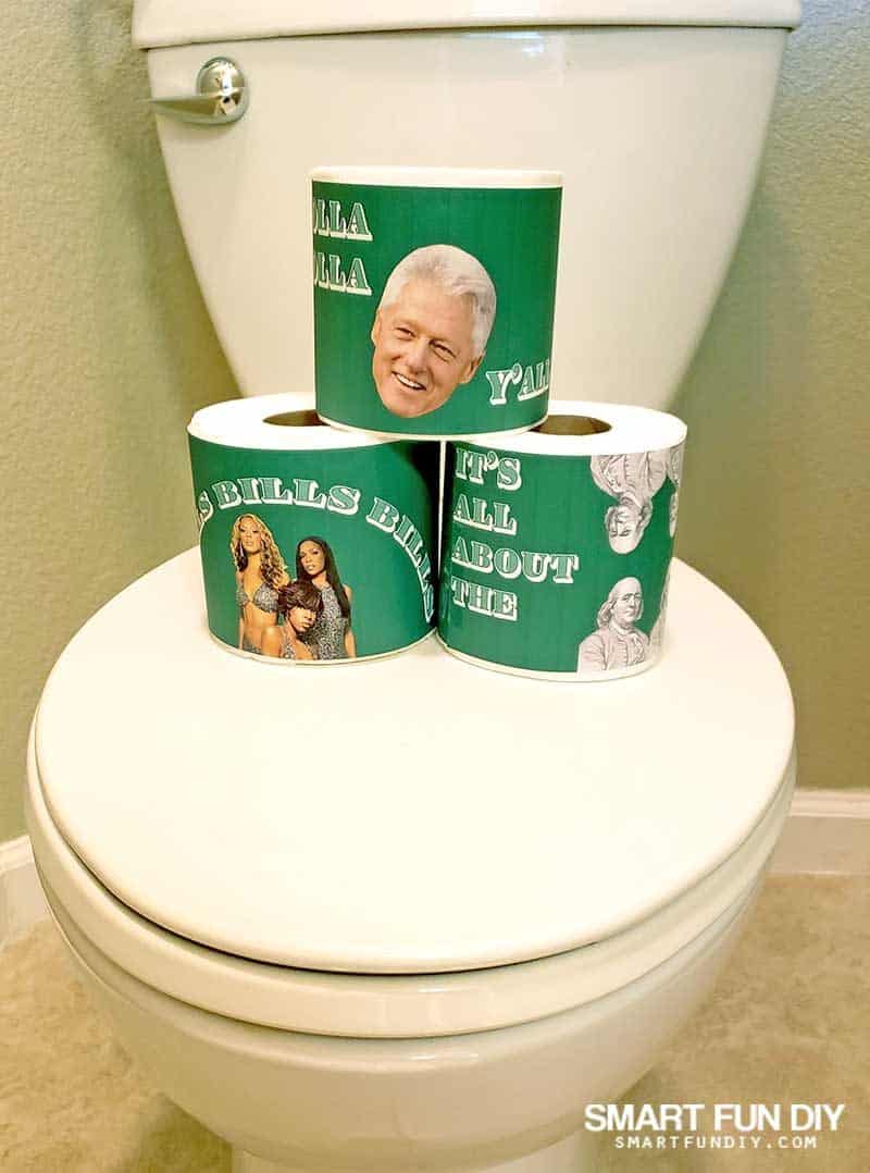 rolls of toilet with silly printable wrappers stacked on toilet