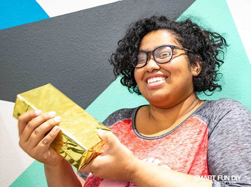 girl reacts to fake gold brick hidden cash gift idea