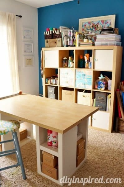 a desk and shelves in a craft room