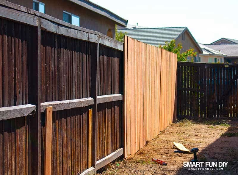 Fence with broken slats and new slats