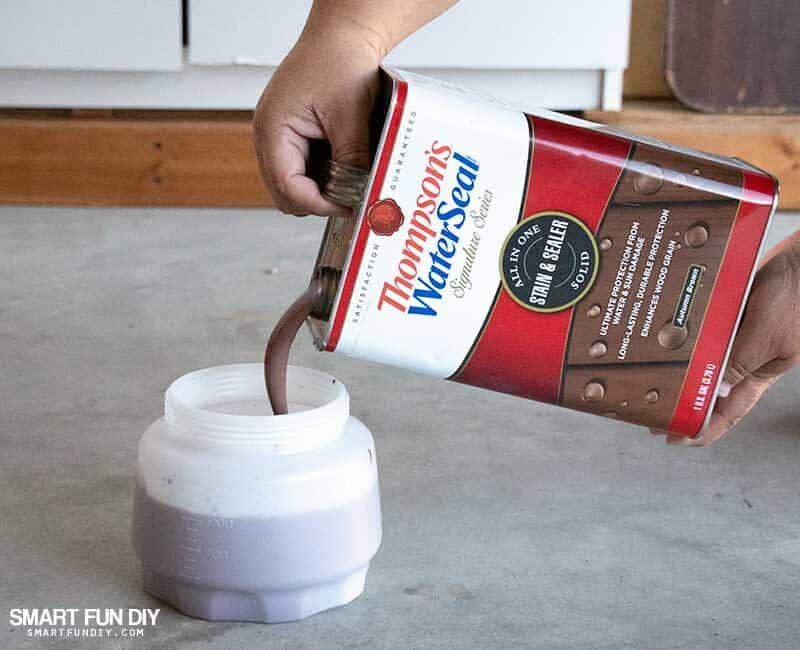 Pouring Thompsons WaterSeal wood stain into Wagner Flexio sprayer container