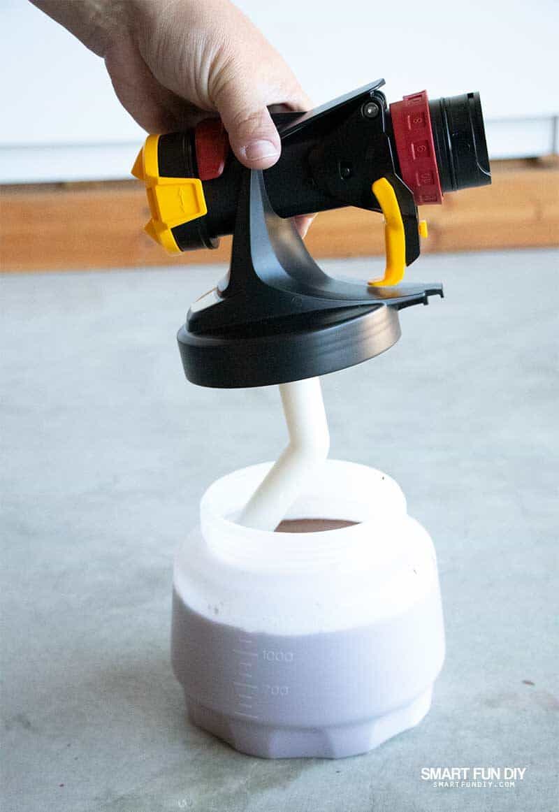 assembling Wagner Flexio Sprayer with container of wood stain