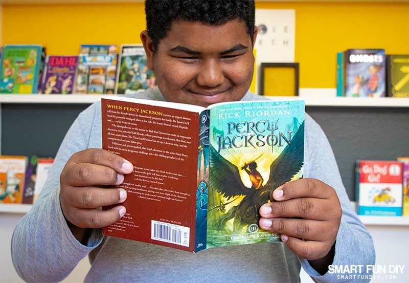 boy reading Percy Jackson and the Olympians