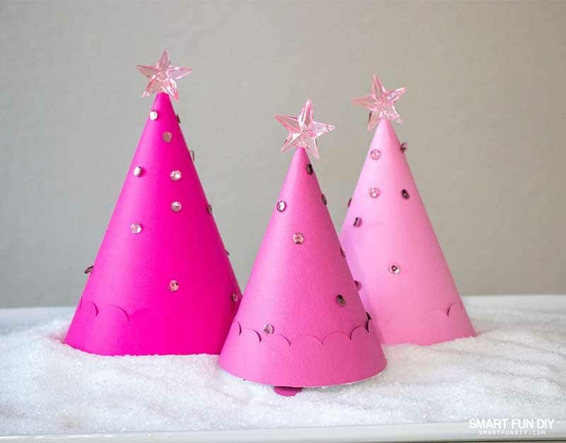 3 pink paper Christmas Tree cones filled candies nestled on a platter covered with epsom salt "snow"